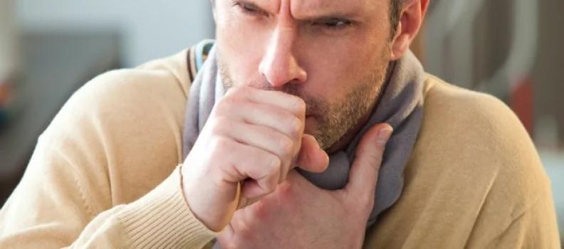 man heavily coughing