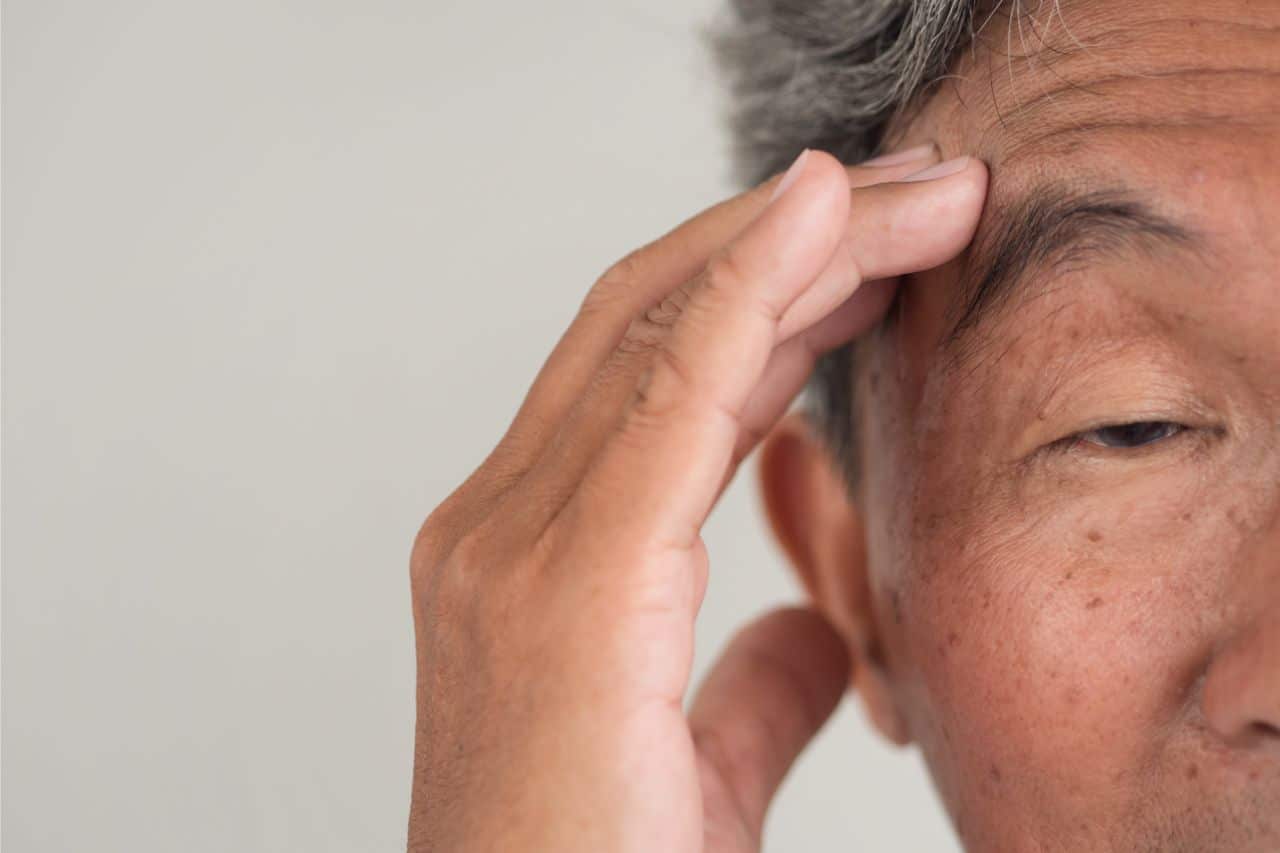 Senior man experiencing headache