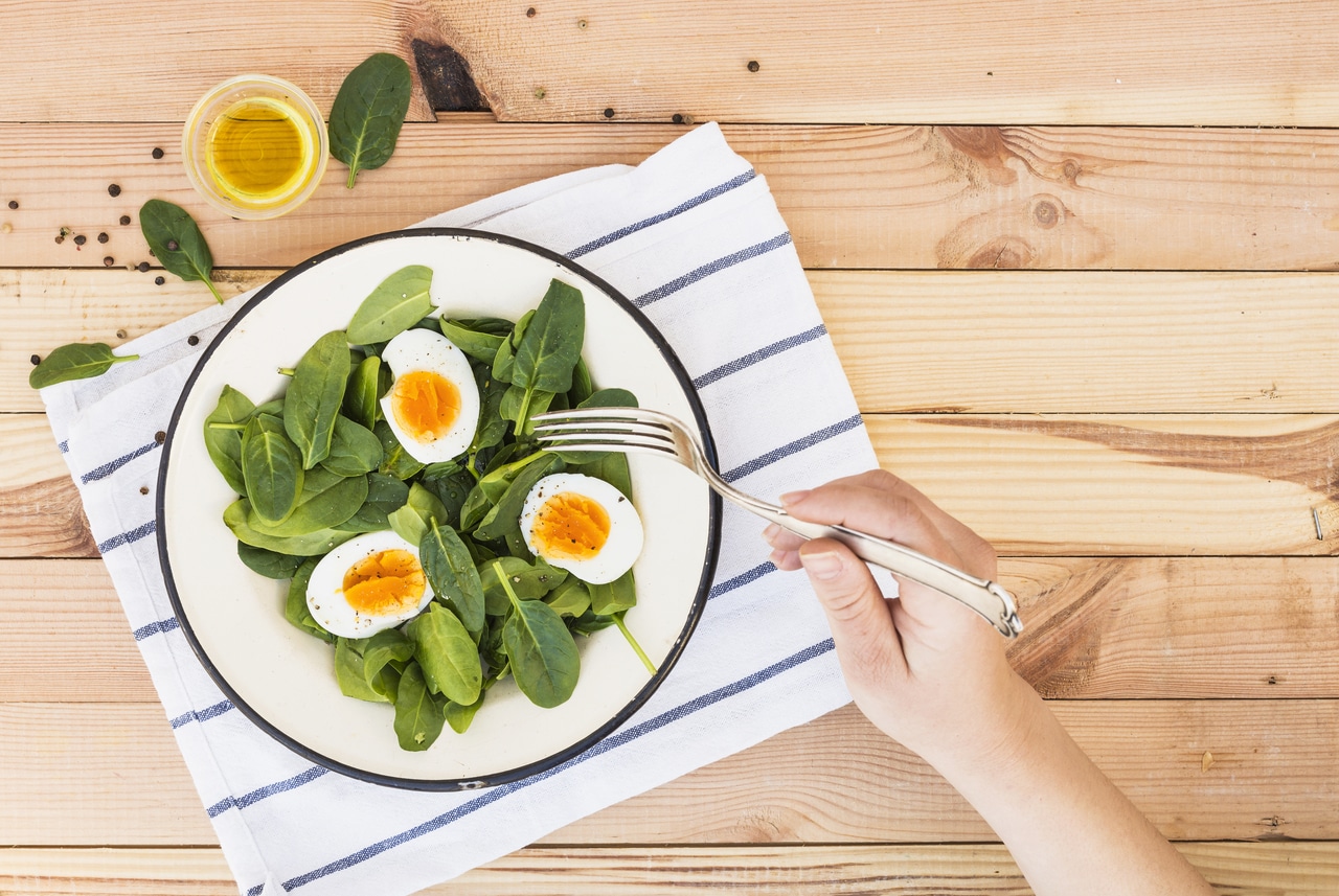 A spinach salad with egg